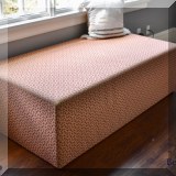 F32. Large ottoman with orange upholstery. 18”h x 60”w x 31”d 